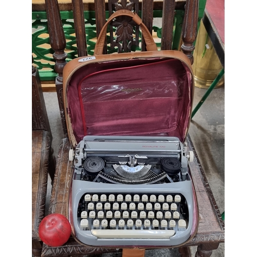 923 - A vintage Royal typewriter in the Royalite 100 model. Housed in leather carrier. Complete with all k... 