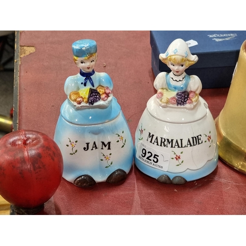 925 - A lovely pair of ceramic marmalade and jar preserve jars in the form of ladies in dresses carrying f... 