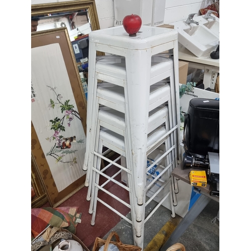 947 - A set of five metal stacking bar stools in white. In good order.