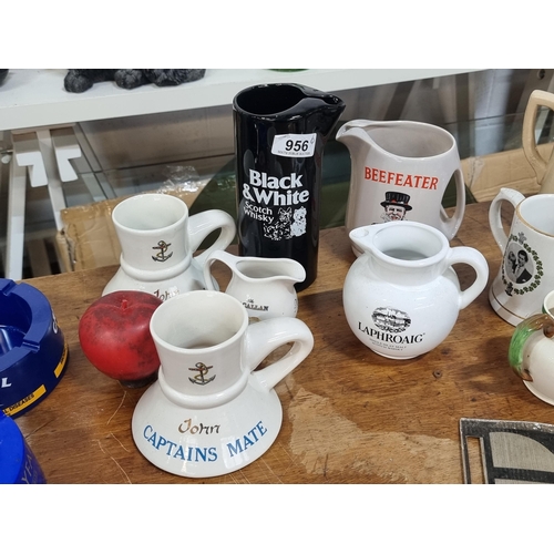 956 - A mixed lot of six vintage ceramic breweriana items. Including a Beefeater Gin pitcher jug by Wade a... 