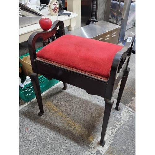 967 - A vintage wooden piano stool with hinged seat and tapered legs.