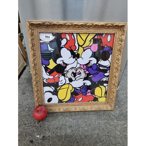 969 - An interesting Mickey Mouse print held in an elaborately carved gilt wooden frame.