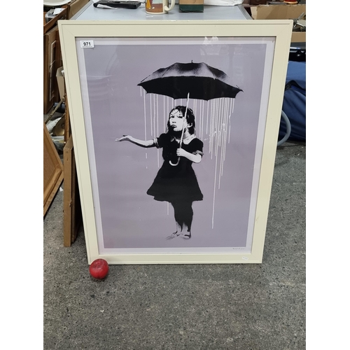 971 - A large print of an iconic  Banksy artwork held in a heavy high quality wooden frame in a cream fini... 