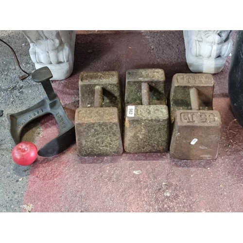 982 - A trio of antique weights. Inc 3 x 56lbs one marked Avery  and a black shoe last.