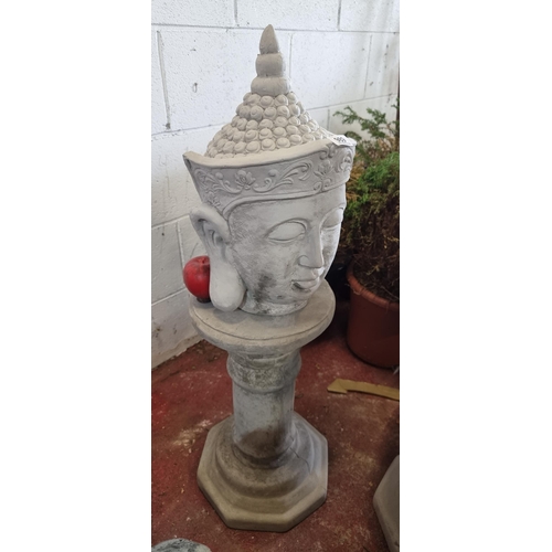 989 - Star Lot - A reconstituted stone Buddha head pillar. A lovey garden display piece. H93cm