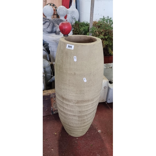 995 - A large ceramic standing vase. A large floor standing model with textured detail to base. H73cm