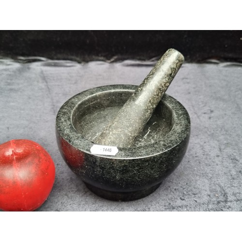 1008 - A heavy black marble mortar and pestle. In good condition.