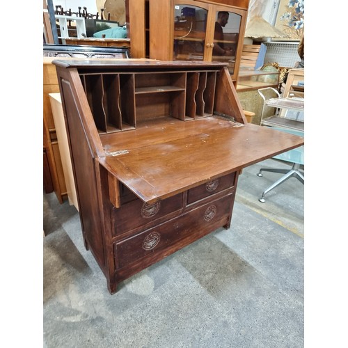 573 - A handsome vintage writing desk with carved Chinese ''Good Luck'' emblem handles. Featuring five dra... 