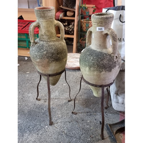 985 - Two vintage terracotta amphora jugs each accompanied by a cast metal display stand. Ideal for patio ... 