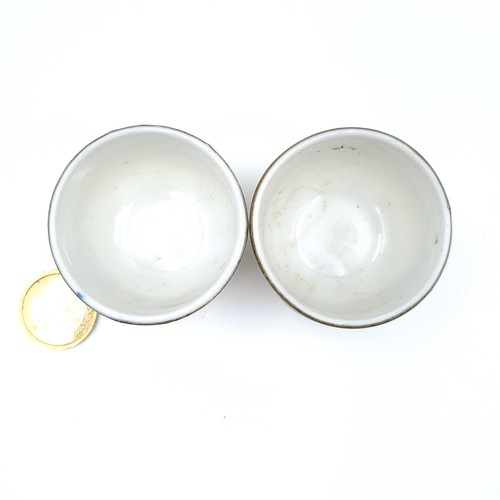 8 - A pair of antique  porcelain Japanese metal rimmed tea bowls, featuring scroll and traditional garde... 