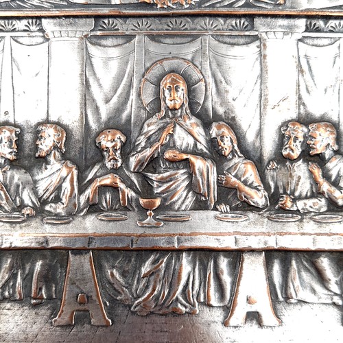 33 - A silver plated wall embossed plaque depicting the last supper and featuring scroll and vine border ... 