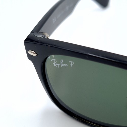 44 - A pair of genuine Ray-Ban sleek black framed sunglasses, featuring dark lenses. In good, clean condi... 