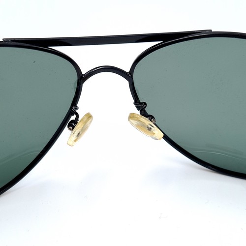 47 - A pair of genuine wrap around Ray-Ban faux black metal framed sunglasses, featuring dark lenses. In ... 