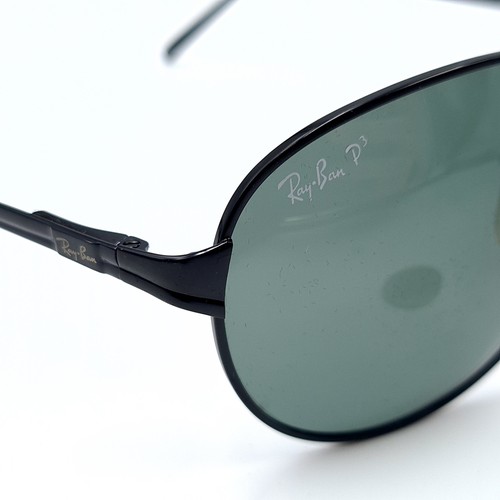 47 - A pair of genuine wrap around Ray-Ban faux black metal framed sunglasses, featuring dark lenses. In ... 