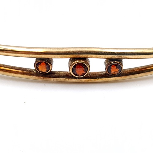 51 - A fine example of a vintage 9 carat gold metal core bracelet, featuring a safety chain and three bea... 