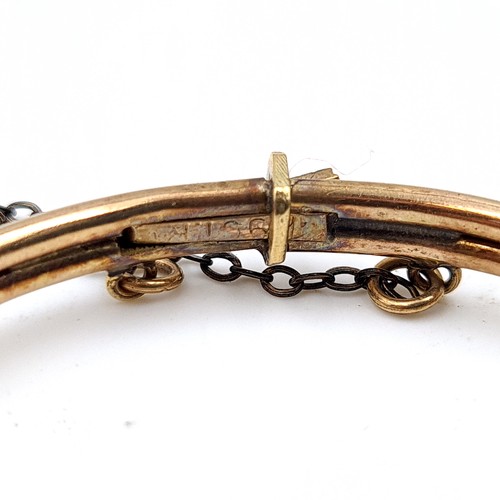 51 - A fine example of a vintage 9 carat gold metal core bracelet, featuring a safety chain and three bea... 