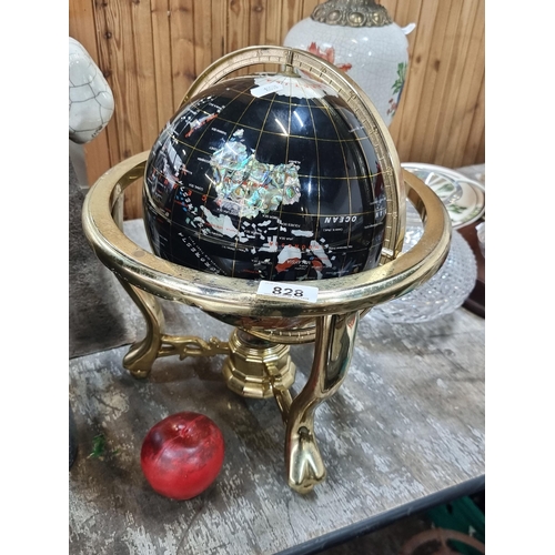 828 - A heavy spinning Lapiz world globe with gemstone inlay and compass to base. Suspended on a gimbal me... 