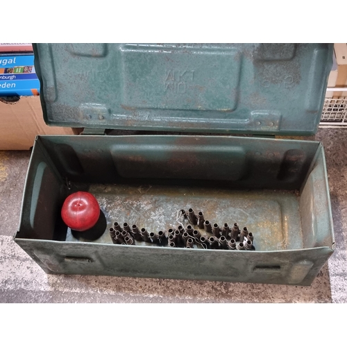 838 - A vintage 1945  military ammunition box with a spent ammunition belt.