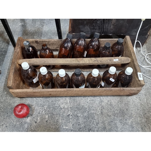 841 - A selection of fourteen vintage chemist's bottles. All with caps. Housed in a wooden tray. Along wit... 