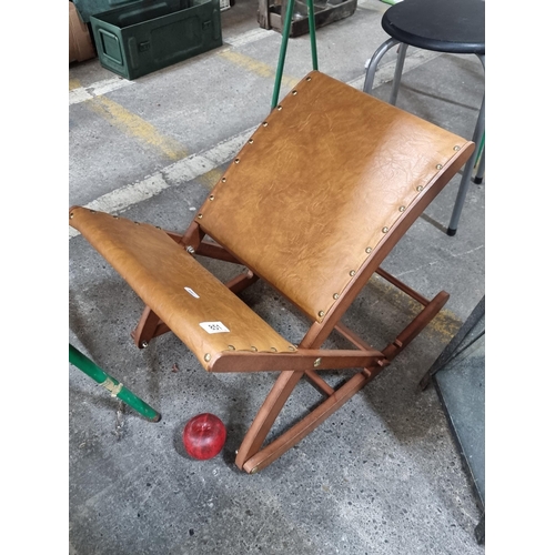 851 - An adjustable rocking Gout stool / footrest. Foldable design with leather and brass studwork.