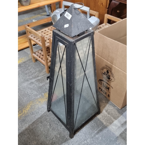 861 - A large metal and glass candle garden lantern.