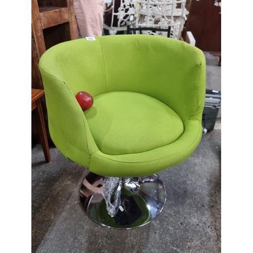 868 - Star Lot : A striking contemporary swivel chair with a lime green fabric upholstery and a polished c... 