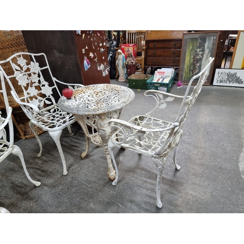 903 - Star lot : Three garden furniture items including a heavy cast iron round table and a pair of chairs... 