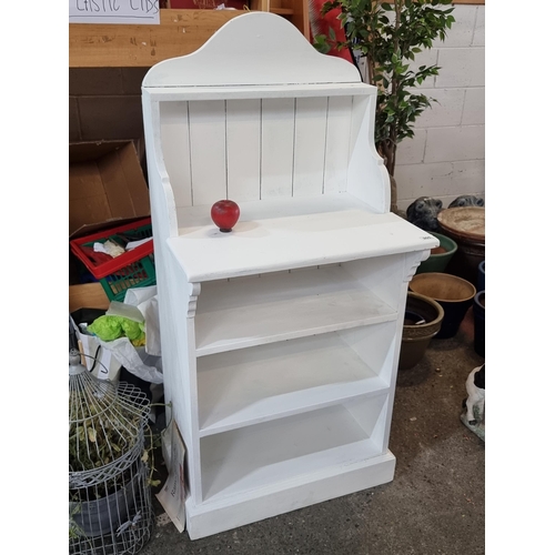 905 - A charming painted pine  shelving unit with curved pediment back, work surface to top and two shelve... 