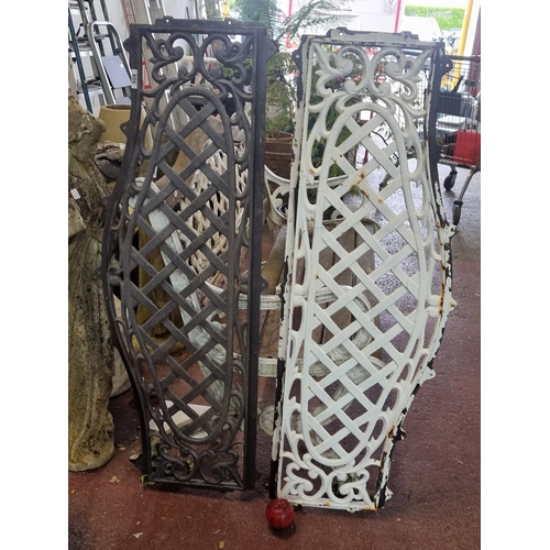 908 - Two wrought iron garden bench back panels, both boasting lovely lattice and foliate design. One in a... 