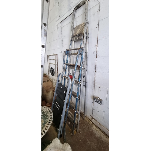 912 - Three step ladders including a small three step example, a fold out nine step example and a larger s... 