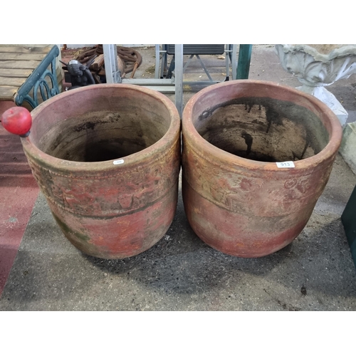 913 - A very large pair of terracotta planters with a figurative frieze to stem in relief. Drainage hole t... 