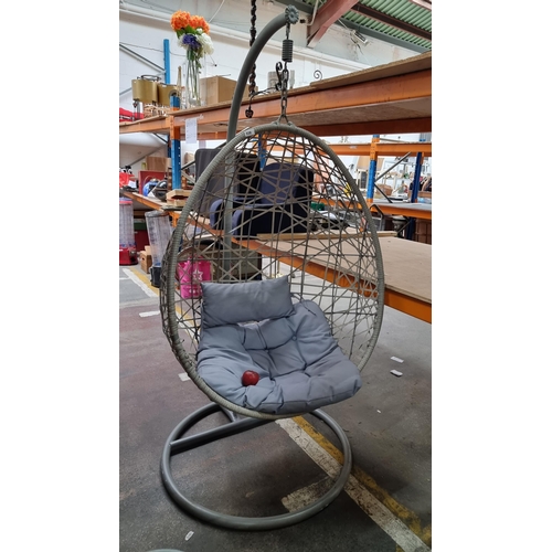 938 - A gorgeous hanging egg chair in a stylish pebble grey finish. Accompanied by a plush seat cushion an... 