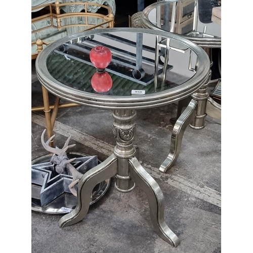 950 - Star lot : A striking side table with mirrored circular tops and pewter toned tripod bases.  In exce... 