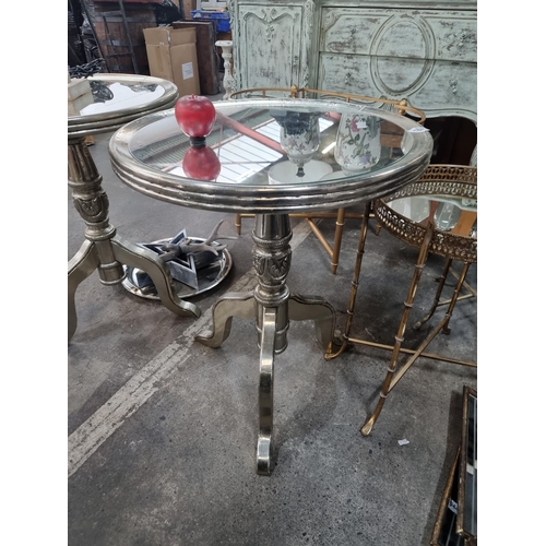 952 - Star Lot : A striking side table with mirrored circular tops and pewter toned tripod bases.  In exce... 