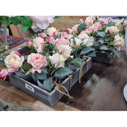 969 - Two grey wooden trays with twelve artificial potted rose flowers each. The twenty-four roses can be ... 