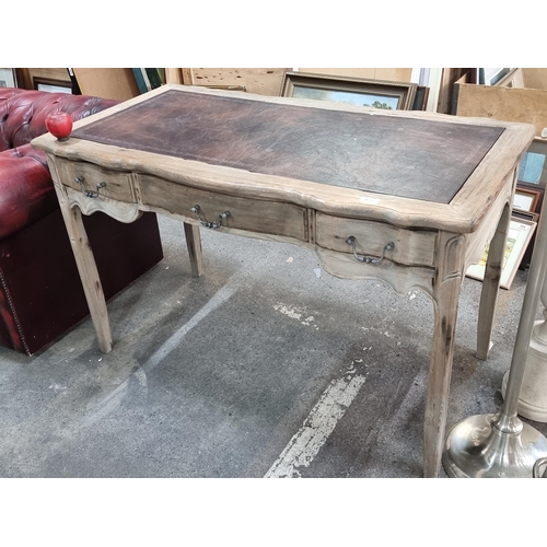 972 - Star Lot : A handsome serpentine fronted console table / desk . Featuring a tooled leather inlay top... 