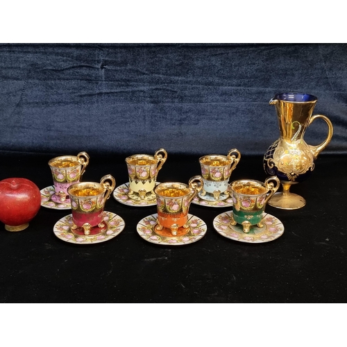 113 - A wonderful thirteen piece gilded tea service with highly ornate cups and saucers featuring court sc... 