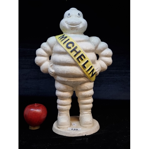 135 - A large very heavy cast metal advertising figure for Michelin tyres. H39cm.