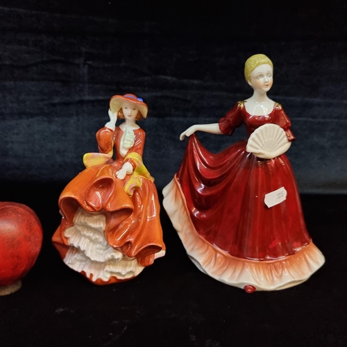 142 - Two elegant porcelain figures of ladies in big dresses. Including a Royal Doulton example on the lef... 