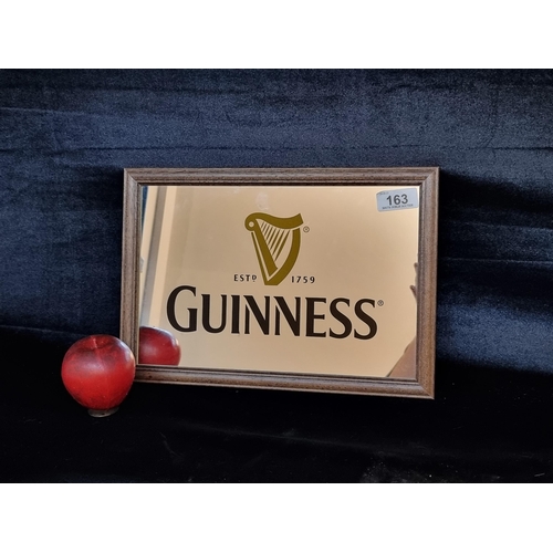 163 - A pub vintage advertising mirror for Guinness. Housed in a wooden frame.