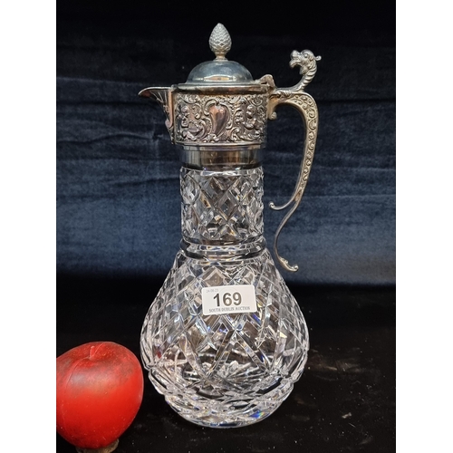 169 - Very intricate antique Claret jug with crystal base and highly detailed repose EPNS top and handle. ... 