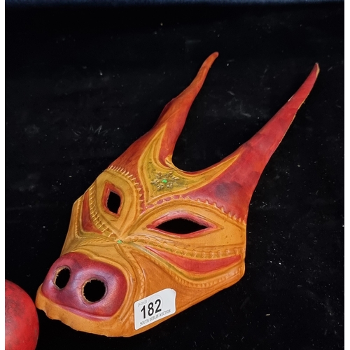 182 - A genuine leather tribal mask with tooled detail and long ears.