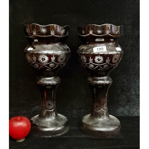 195 - A pair of tall dark ruby glass lustres. Featuring geometric pattern and scalloped rim. In very good ... 