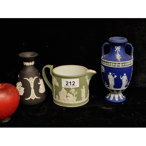 212 - Three vintage Wedgwood jasperware vessels. Including a matte black bud vase, a cobalt blue amphora b... 