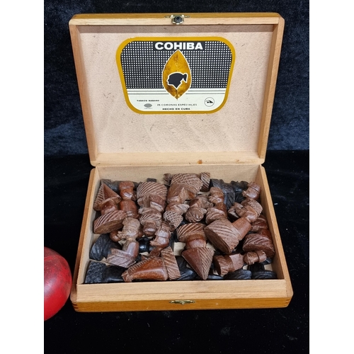 214 - A Cohiba Coronas box containing a full set of 32 pieces of African carved wood chess pieces. Nice he... 