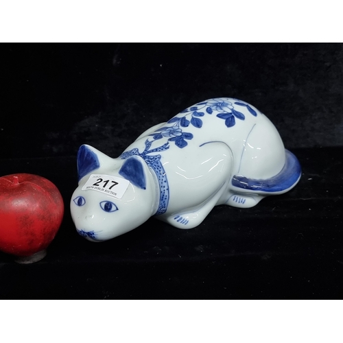 217 - A large Chinese porcelain cat figure with handpainted blue collar and floral motifs. L30cm