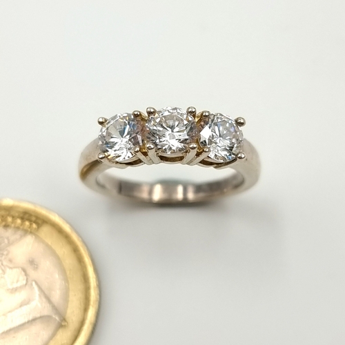 48 - A very attractive super sparkly three stone bright White Moissanite wide band ring. Unmarked, possib... 