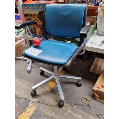 A 1970's vintage operator swivel chair by Bendt Winge, Oslo. Upholstered with teal sheepskin leather. Adjustable height and swivel feature. With maker's stamp.