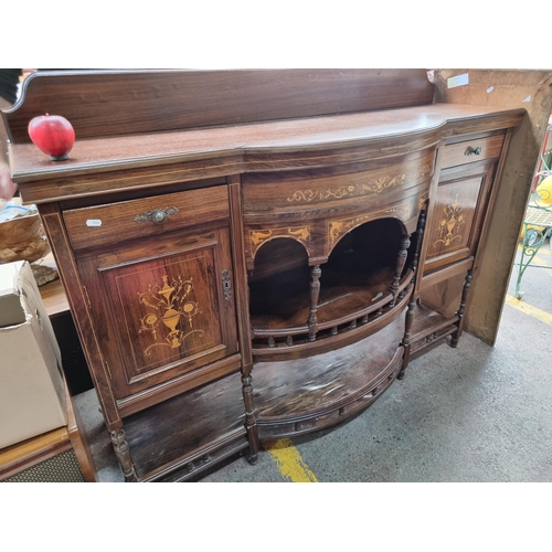 Star Lot : A gorgeous Edwardian bow-fronted sideboard with a wonderful Regency style marquetry design to front. With gallery back, two drawers, cabinet space and shelves to centre boasting balustrade detail. H120cm x W152cm x D50cm
