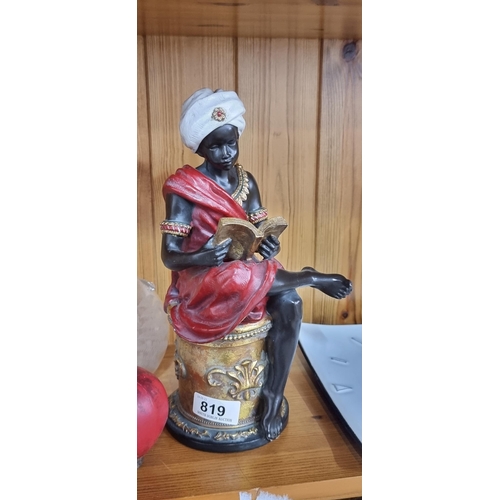 819 - A heavy figurine in the form of an Arabian nobleman seated having a read through his book. Beautiful... 